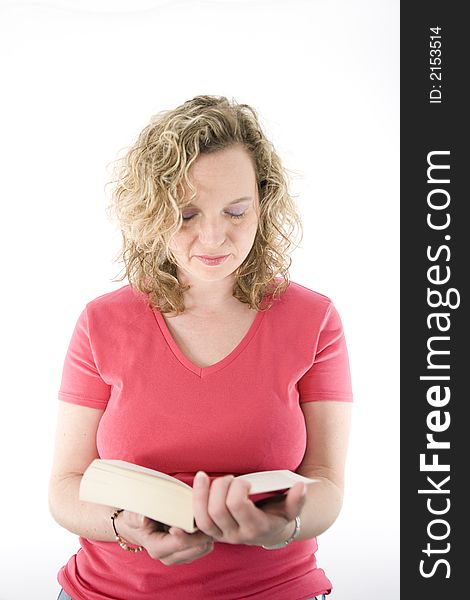 Attractive blonde reading a book isolated on white