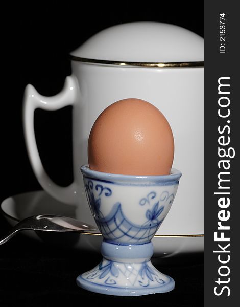 Egg on the support, cup, saucer and tea spoon. Egg on the support, cup, saucer and tea spoon.