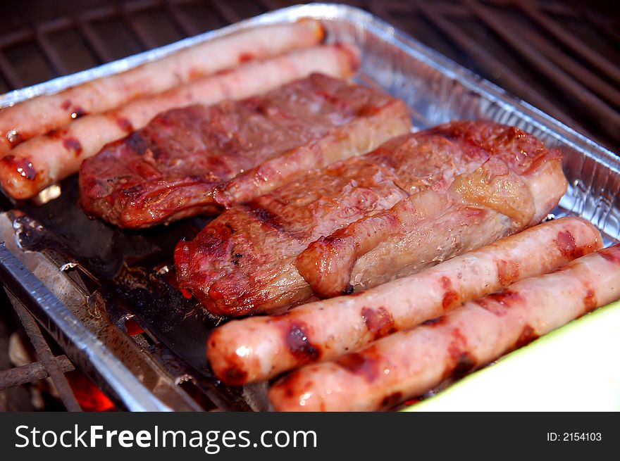 Barbecque plate with steaks and sausages. Barbecque plate with steaks and sausages