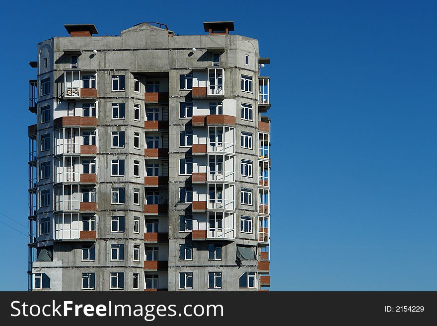 Not completed building against a blue sky.