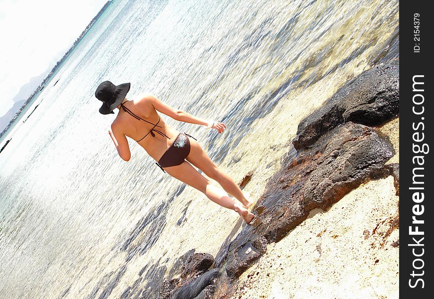 A woman standing in the water wearing a bikini. A woman standing in the water wearing a bikini