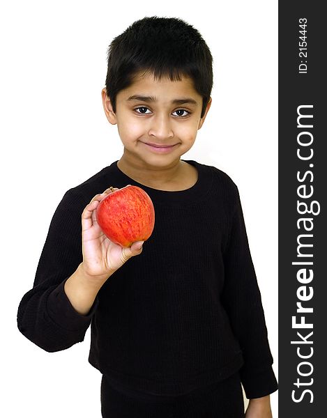 An handsome indian kid holding a red apple. An handsome indian kid holding a red apple