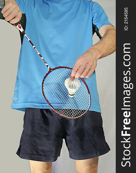 Player makes a badminton serve isolated on a white background