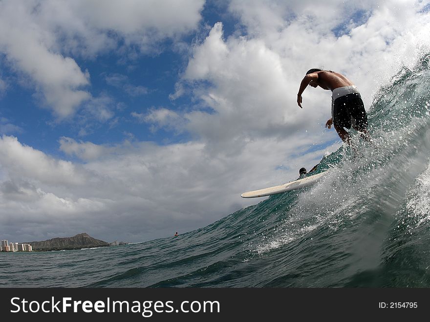 A longboarder surfing in Hawaii