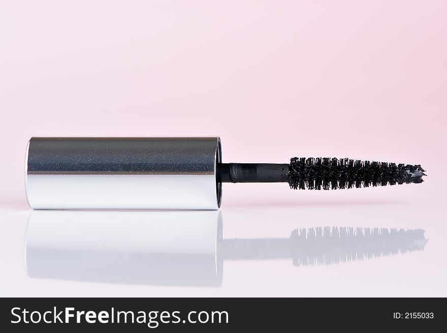 Black mascara with reflection with pink