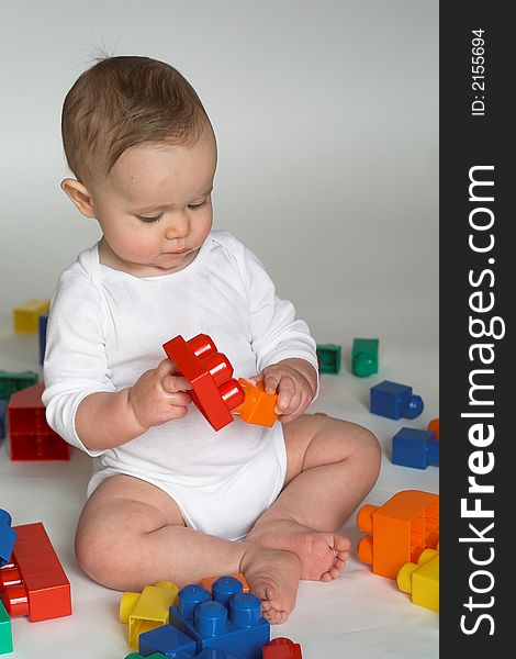 Image of cute baby playing with colorful building blocks. Image of cute baby playing with colorful building blocks