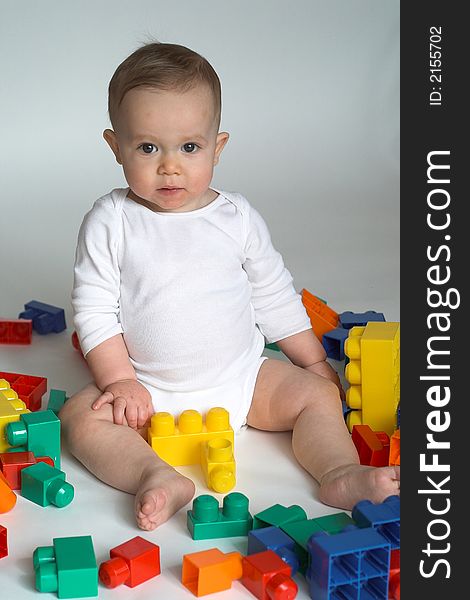 Image of cute baby playing with colorful building blocks. Image of cute baby playing with colorful building blocks