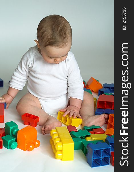 Image of cute baby playing with colorful building blocks. Image of cute baby playing with colorful building blocks