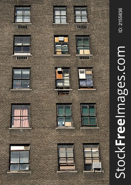 Three rows of windows of an old brick house.