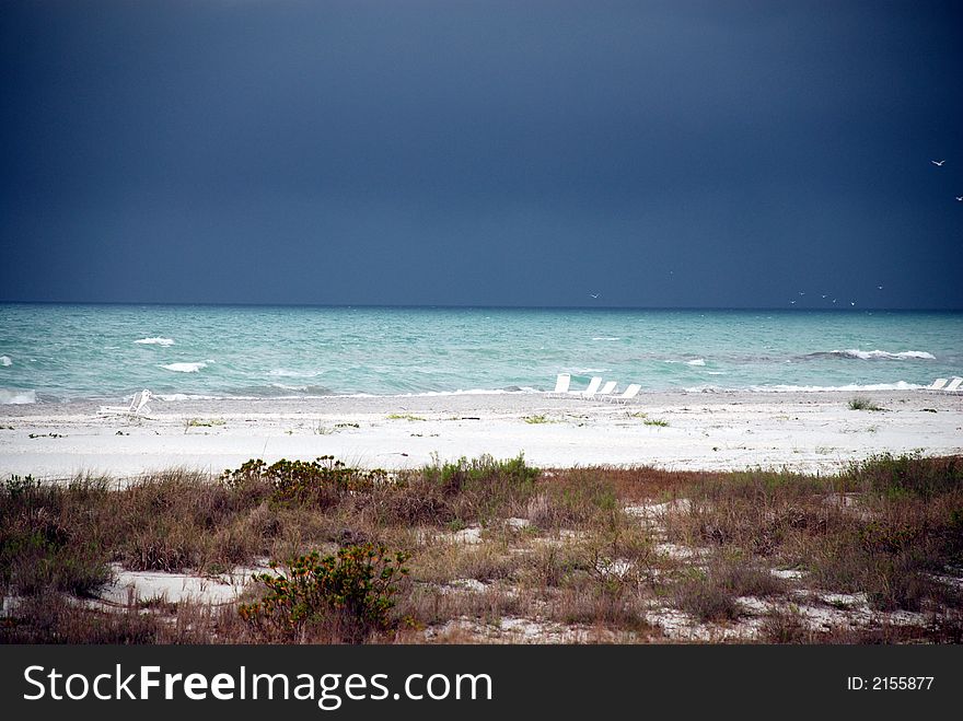 A storm out over the Gulf of Mexico as seen from the beach. A storm out over the Gulf of Mexico as seen from the beach