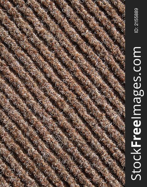 Diagonal lines of a brown striped fabric of a carpet. Diagonal lines of a brown striped fabric of a carpet.