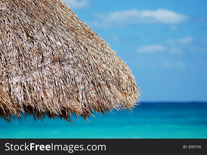 Beautiful Carribbean beach and wicker umbrella. Beautiful Carribbean beach and wicker umbrella