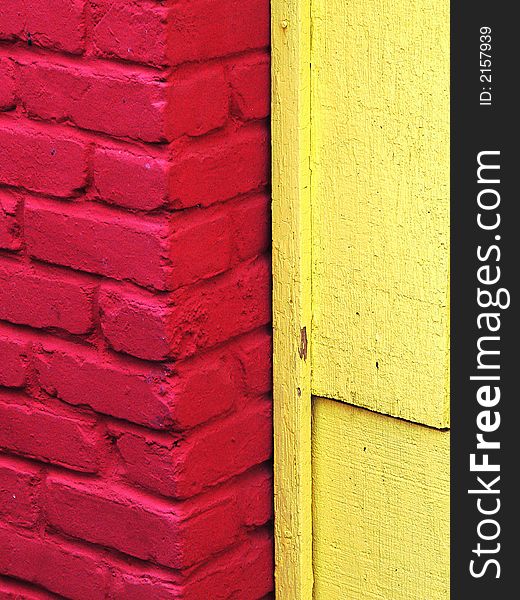 Fire engine red bricks against a lemon yellow wooden wall. Fire engine red bricks against a lemon yellow wooden wall