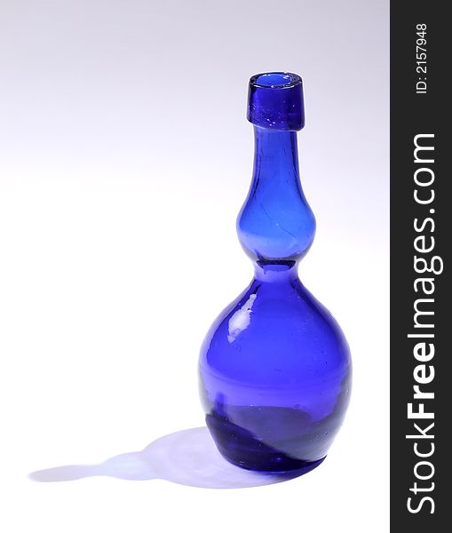 Blue glass bottle with translucent blue shadow