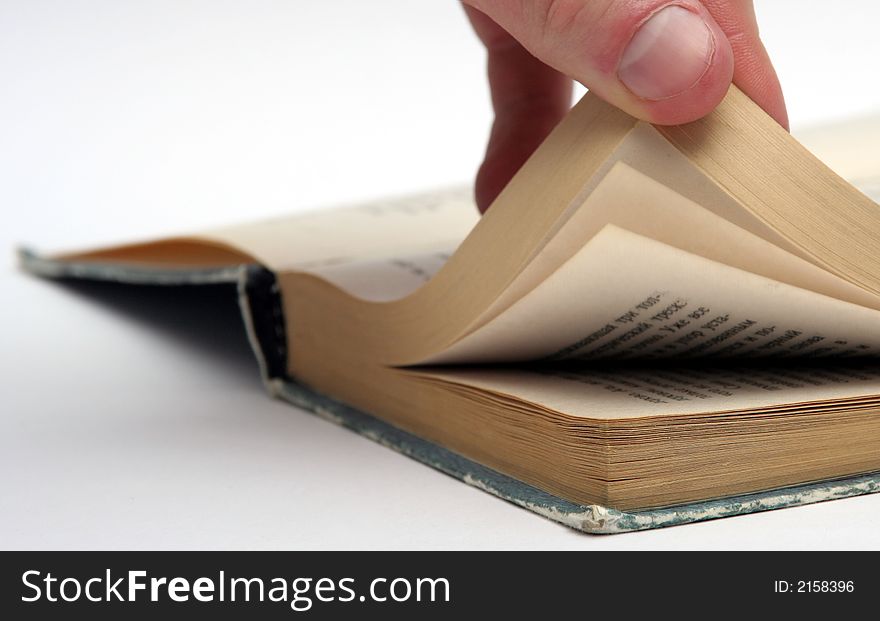 Male hand holding the pages of the old book. Male hand holding the pages of the old book