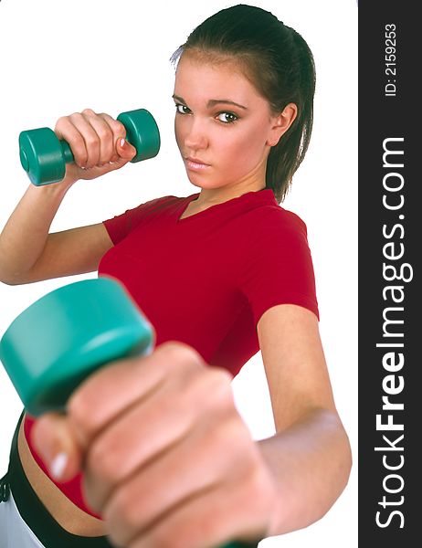 Girl in red sports vest fulfill movement by dumbbells. Girl in red sports vest fulfill movement by dumbbells