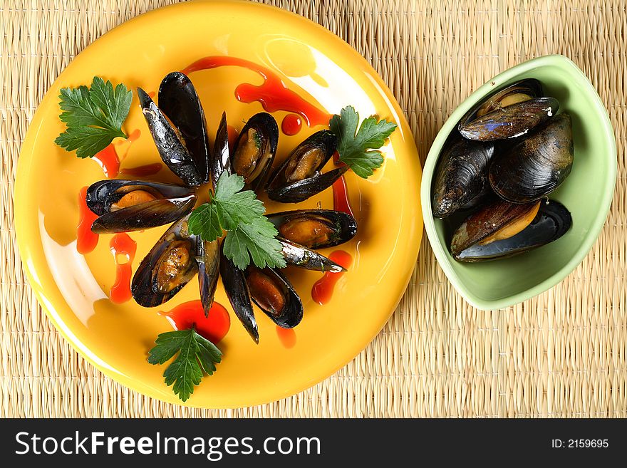 Tasty oven shellfish served in the yellow plate