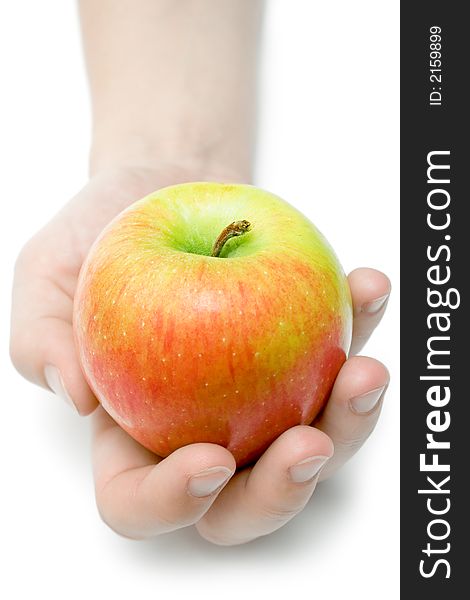 Female hand offering a colorful apple. Isolated on a white background. Female hand offering a colorful apple. Isolated on a white background.