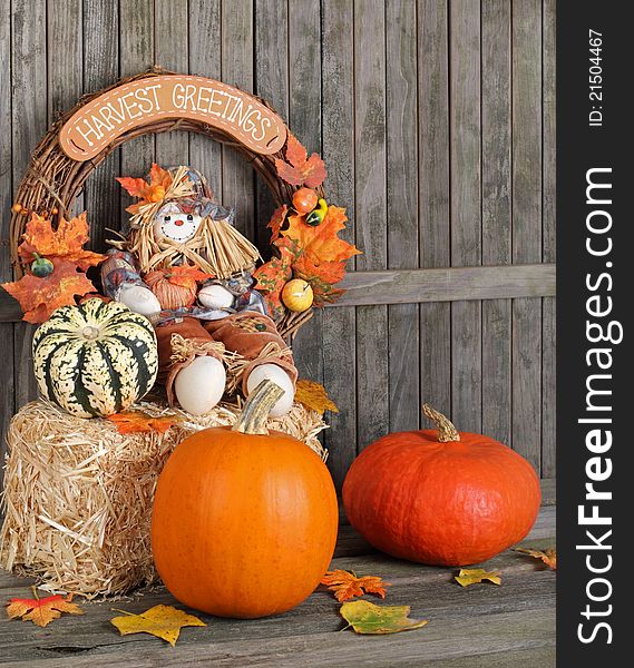 Autumn decorations against a weathered wood fence