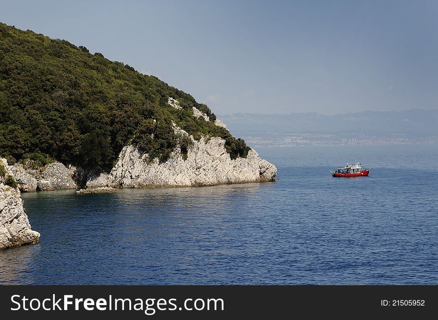 Red diver boat near coast