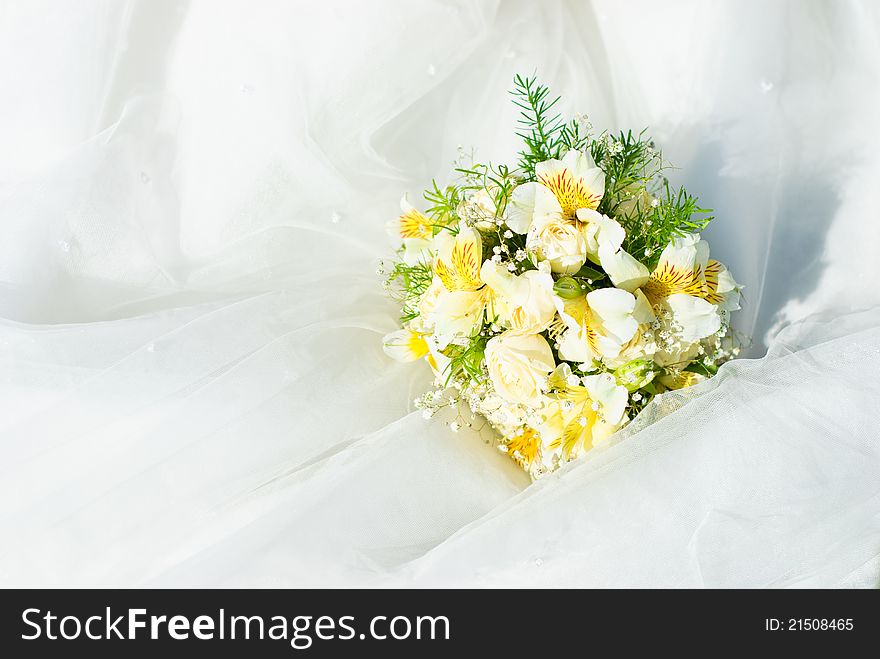 Bridal bouquet of roses on a wedding dress. Bridal bouquet of roses on a wedding dress