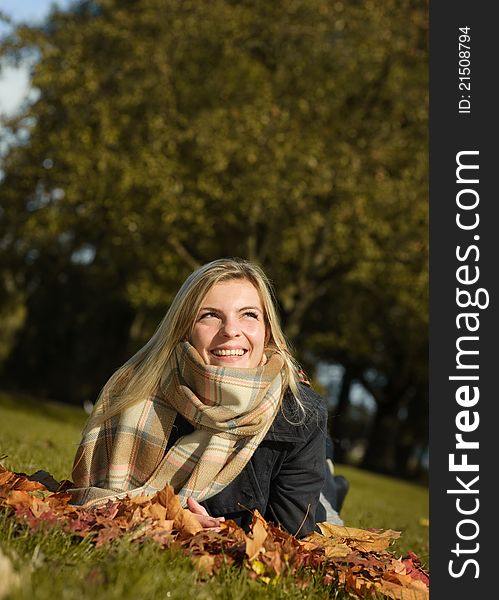 Young beautiful woman enjoying nice autumn weather in park. Young beautiful woman enjoying nice autumn weather in park