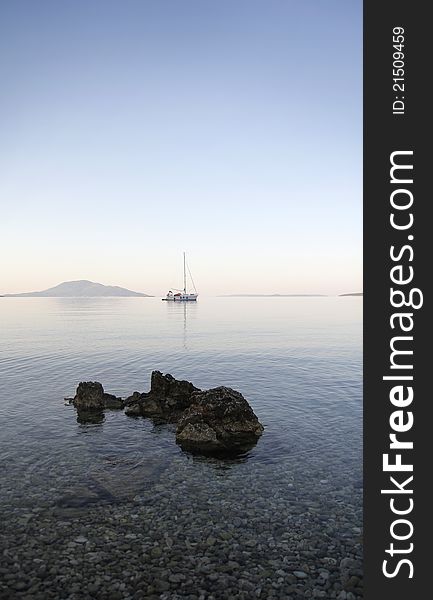 Anchor sailing boat in calm bay and stone in front. Anchor sailing boat in calm bay and stone in front