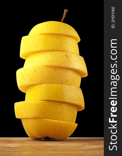 Yellow apple tower on a black background. Clipping paths are included.
