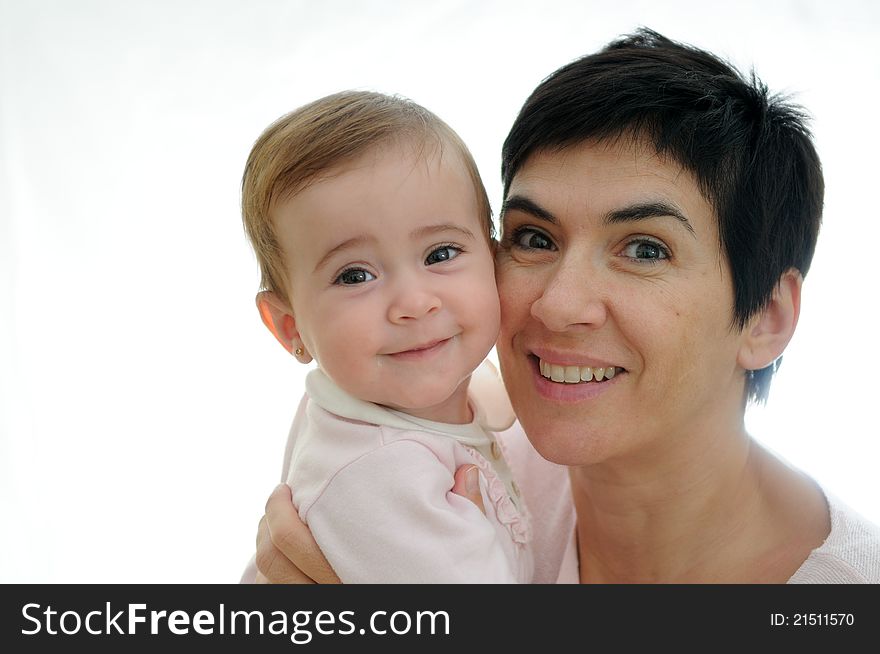 A mother playing with her little baby on white background. A mother playing with her little baby on white background