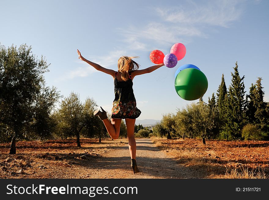 Girl With Balloons In The Field