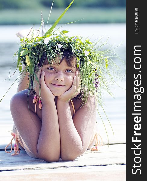 The blue-eyed girl lies and sunbathes on a beach. The blue-eyed girl lies and sunbathes on a beach