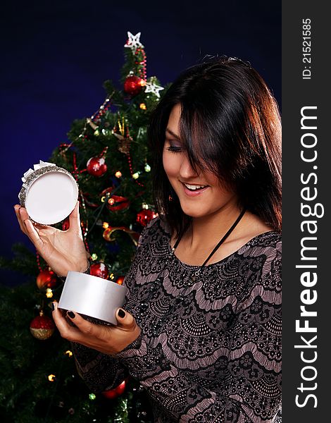 Happy and smiling woman with Christmas gift in hands. Happy and smiling woman with Christmas gift in hands