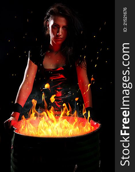 Beautiful Woman And Iron Barrel With Fire Inside