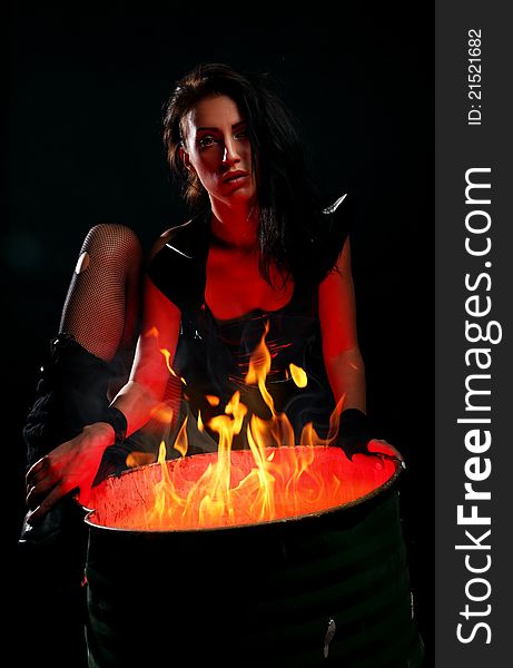 Beautiful Woman And Iron Barrel With Fire Inside