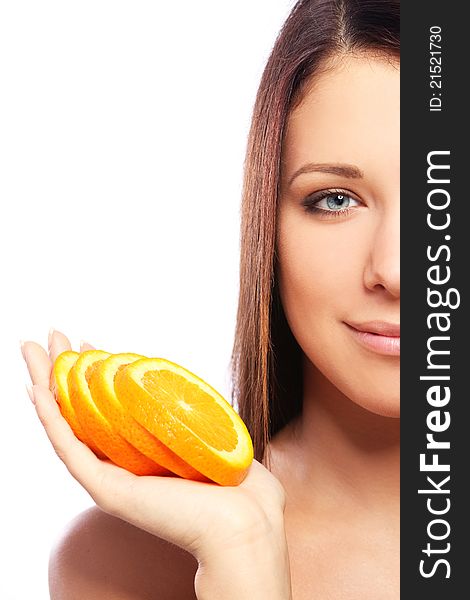 Beautiful woman with orange in hands against white background