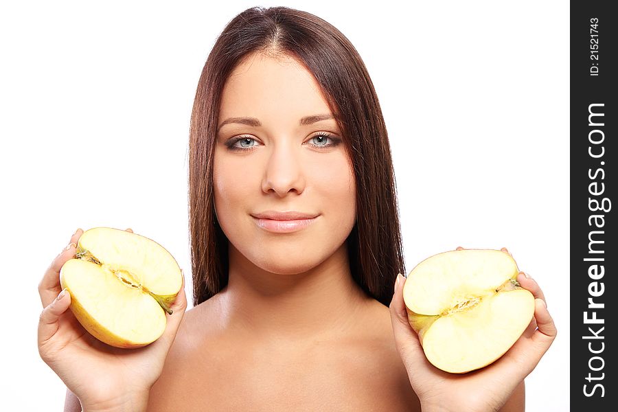 Beautiful woman with apple in hands against white background