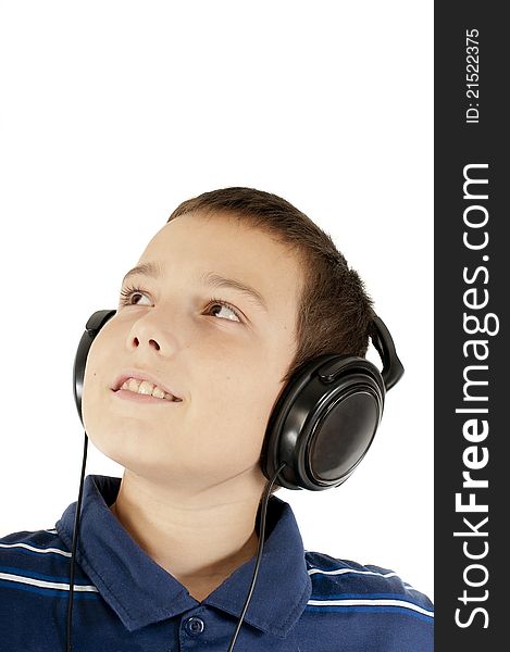 The eleven-year boy listens to music in ear-phones. The eleven-year boy listens to music in ear-phones