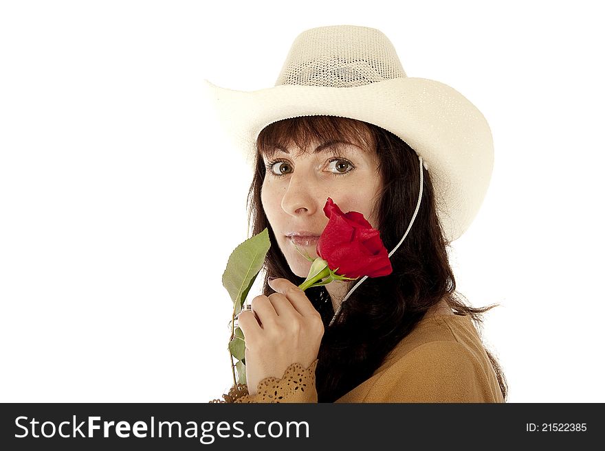 The young girl in a white hat holds a red rose at the person. The young girl in a white hat holds a red rose at the person