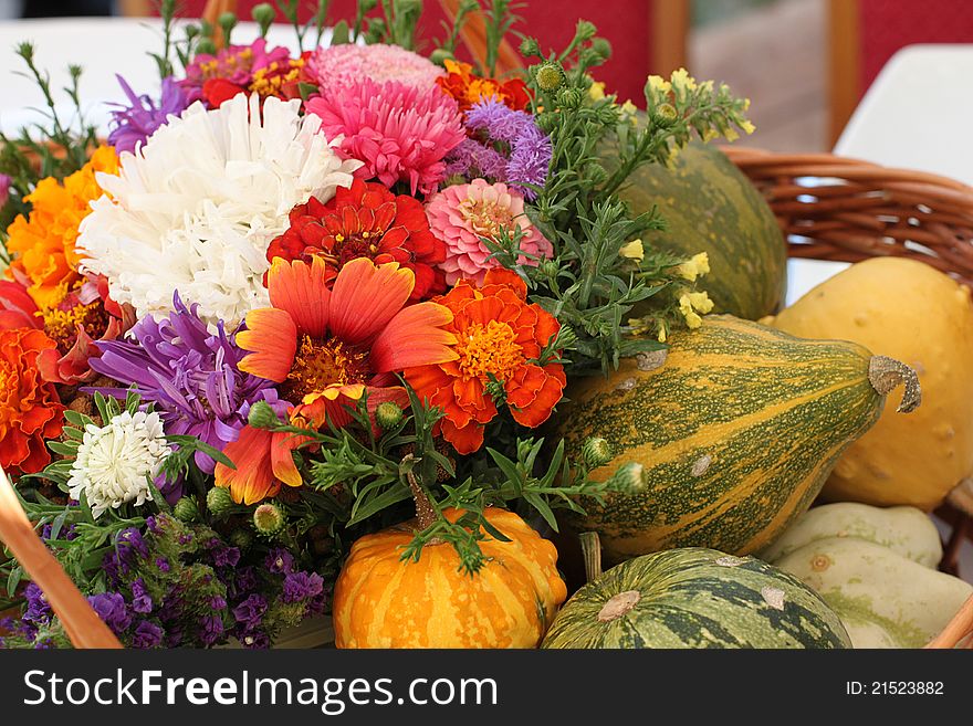 Colorful flower and pumpkin basket on outdoor table. Colorful flower and pumpkin basket on outdoor table.