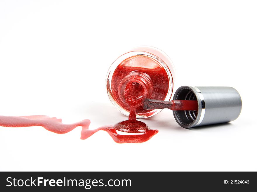 Open nail polish bottle with dropping red glitter nail polish as closeup on white background. Open nail polish bottle with dropping red glitter nail polish as closeup on white background