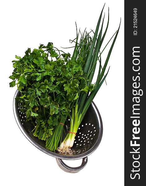 Chive,bulb onion and parsley bundles in colander.