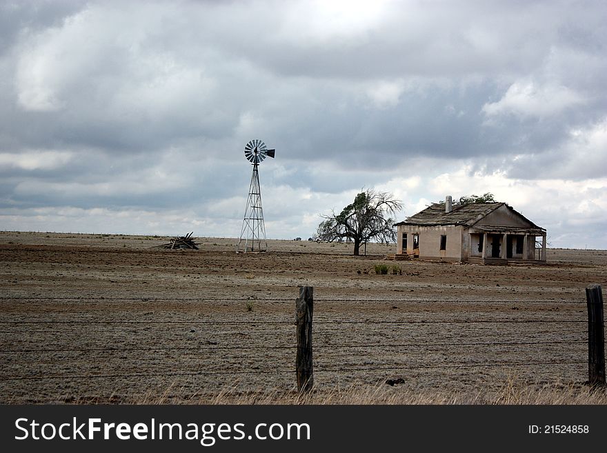 An abandoned farming homestead stands against the weather on the high plains of eastern new mexico, usa;. An abandoned farming homestead stands against the weather on the high plains of eastern new mexico, usa;