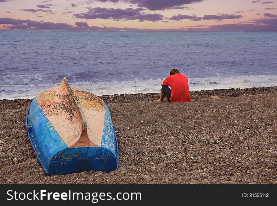 A men and a boat near the sea. A men and a boat near the sea