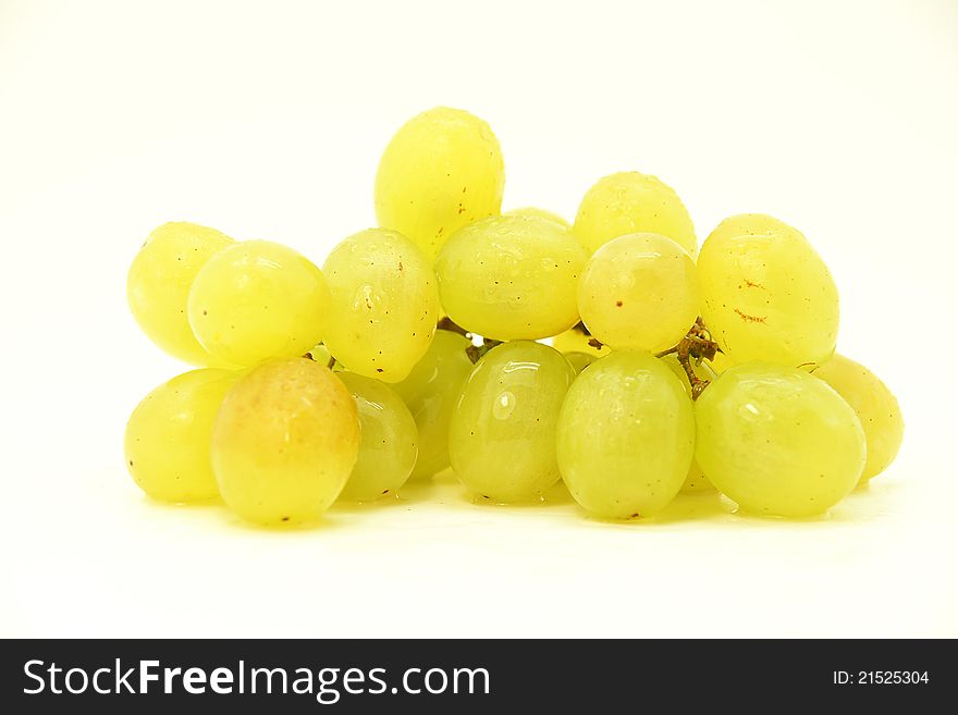 Image of a cluster of green grapes on white fund. Image of a cluster of green grapes on white fund.