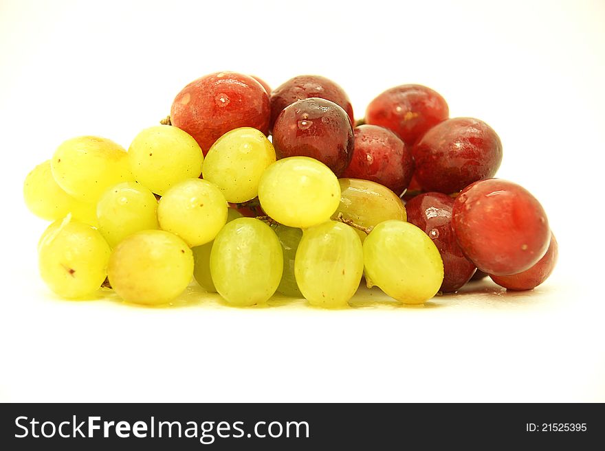 Clusters of white and black grapes on white fund. Clusters of white and black grapes on white fund.