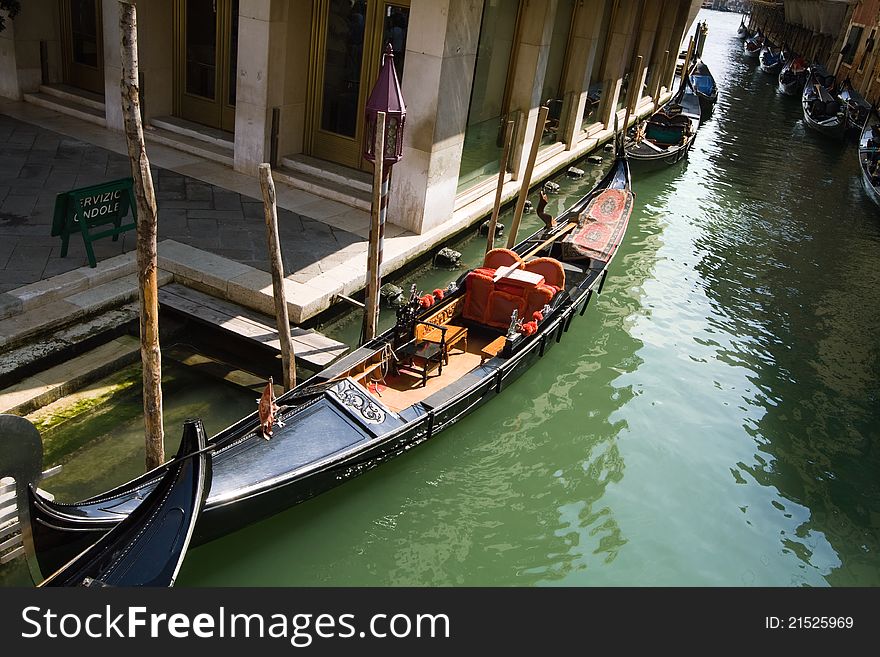 Gondola in Venetian canal, high angle view.