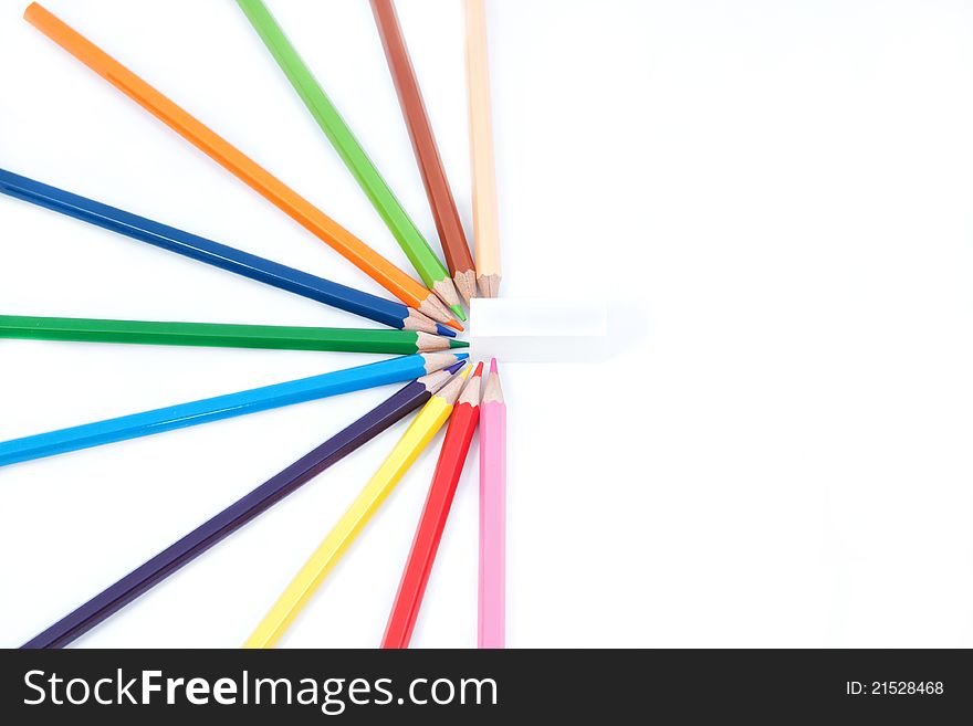 A set of colored pencils in the shape of half a star and eraser. On a white background.