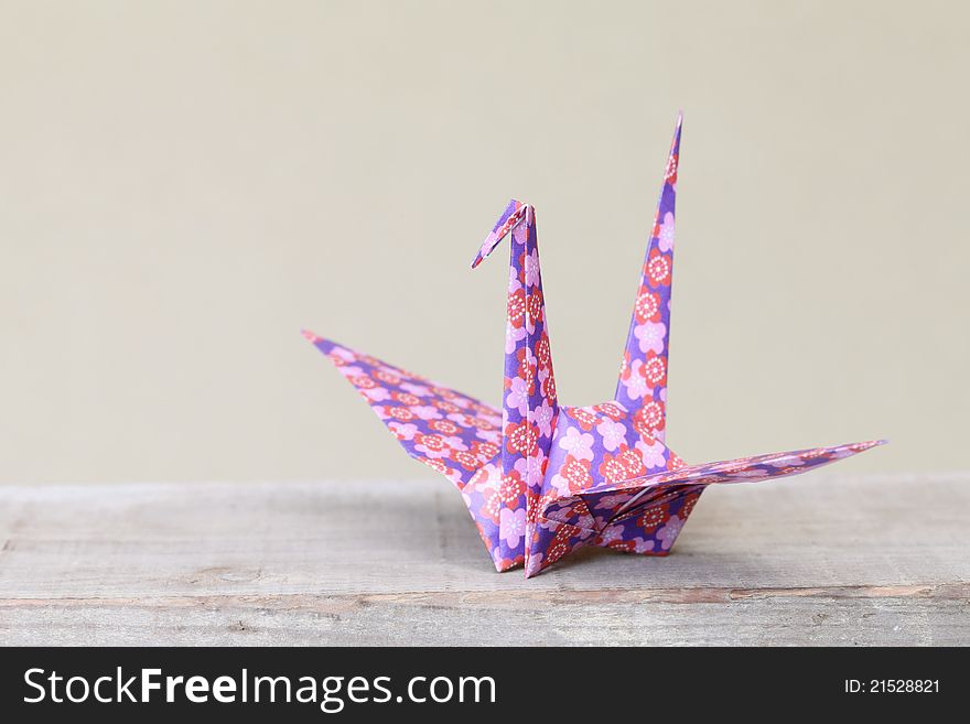 Close up of origami bird on a shelf