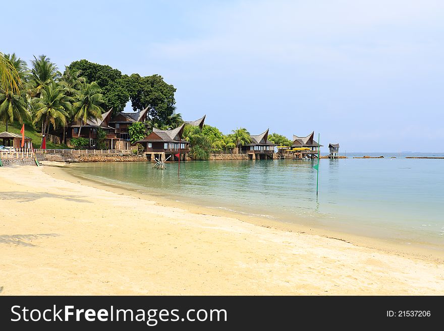 Tropical beach and palm huts