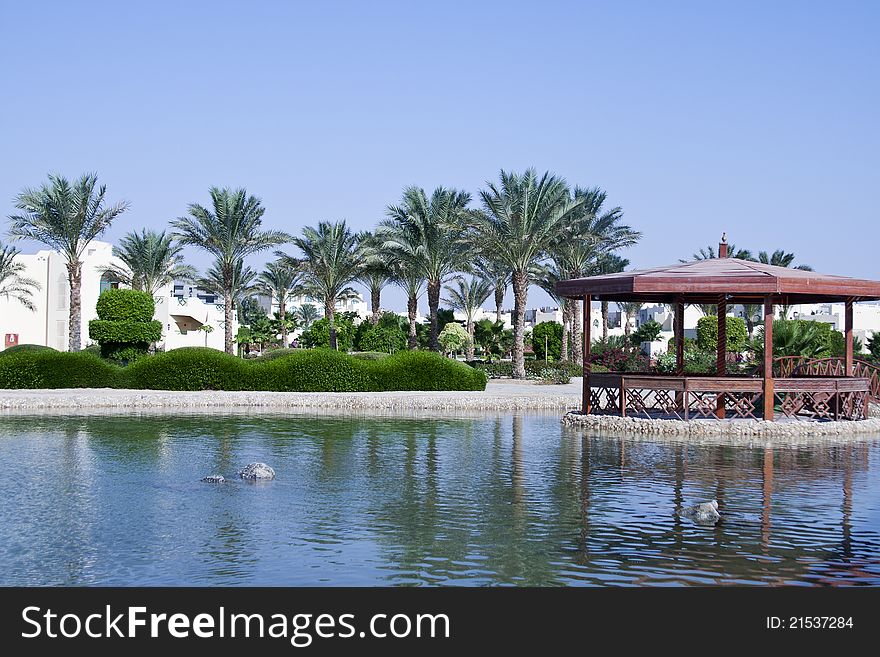 Arbor on the water and palms